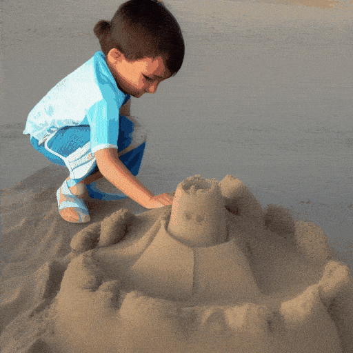 A child building a sandcastle on the beach.